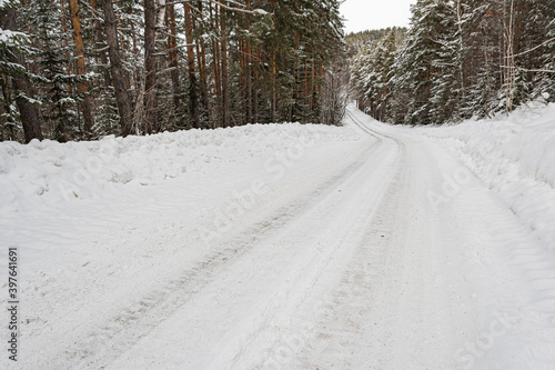Wallpaper Mural Snow road in winter pine forest. Ice and snowstorm on a country road. Clearing the road from snowdrifts. Torontodigital.ca