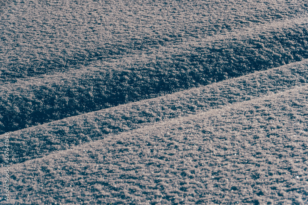 Fototapeta premium Narrow pathway through deep snow in snow field