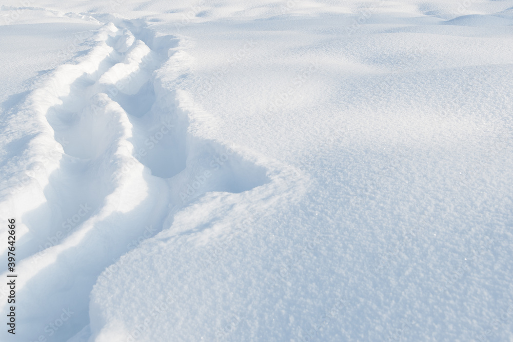 Narrow pathway through deep snow in snow field Narrow pathway through deep snow in snow field