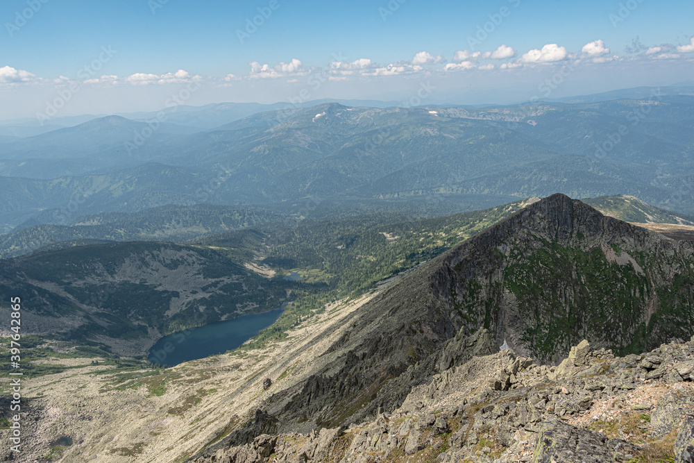 Panoramic view of mountain ranges. Rock ridge with various peaks for rock climbing