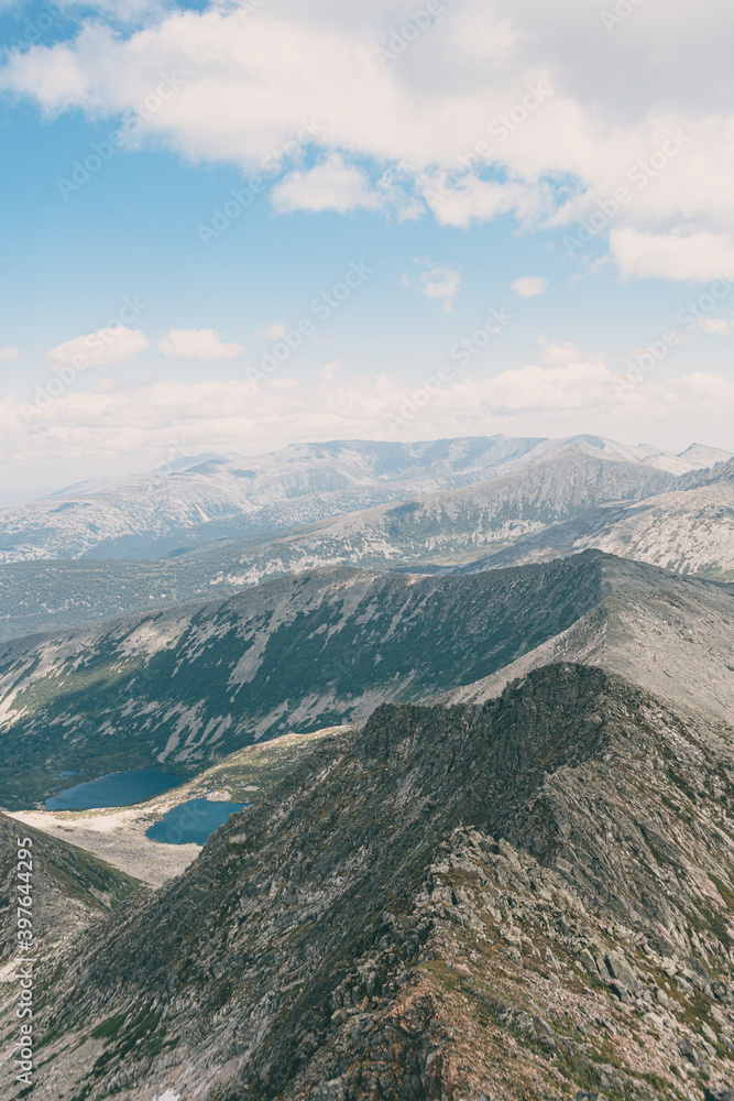 Panoramic view of mountain ranges. Rock ridge with various peaks for rock climbing