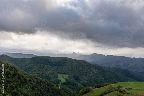 green mountains landscape with gray clouds  dramatic sky