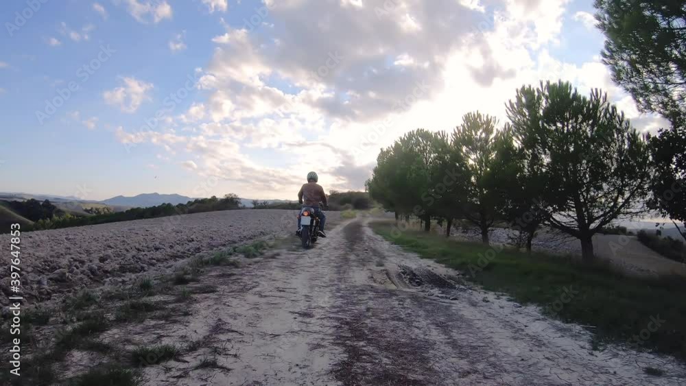 Camera car shot. Man riding red motorcycle in beautiful landscape in Tuscany, Italy. Volterra. Camera car shot. Man riding red motorcycle in beautiful landscape in Tuscany, Italy. Volterra.
