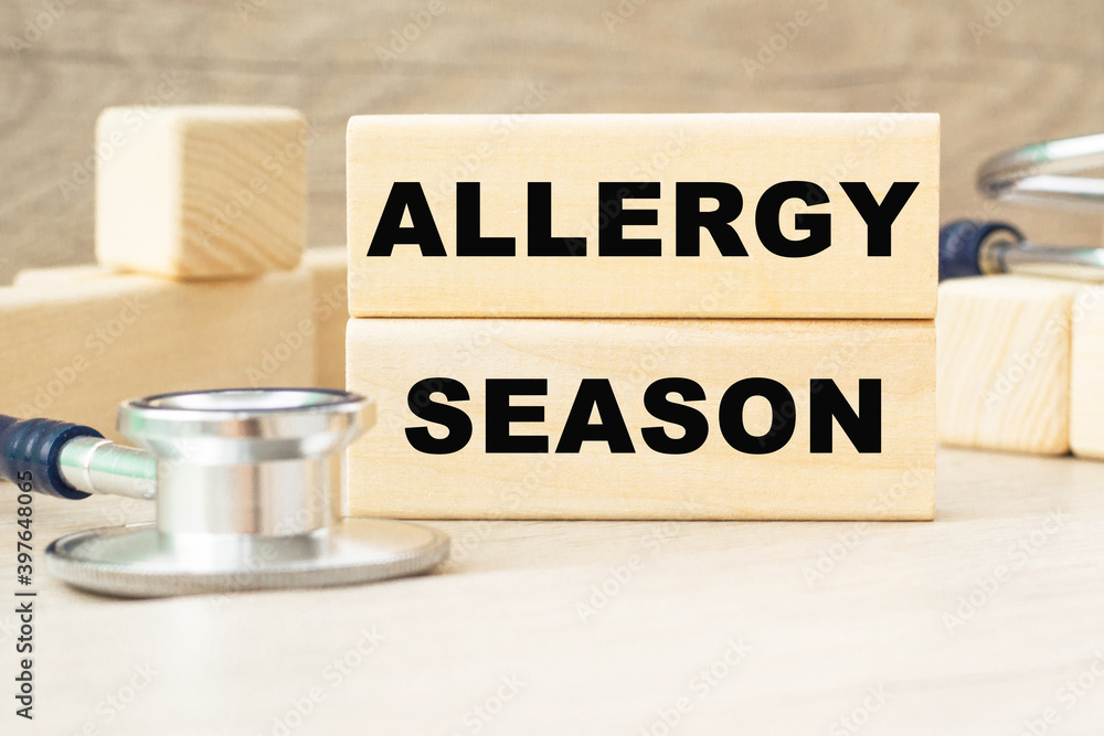 the word ALLERGY SEASON is written on a wooden cubes structure . Cube on a bright background. Can be used for Medical concept. the medicine. the word ALLERGY SEASON is written on a wooden cubes structure . Cube on a bright background. Can be used for Medical concept. the medicine.