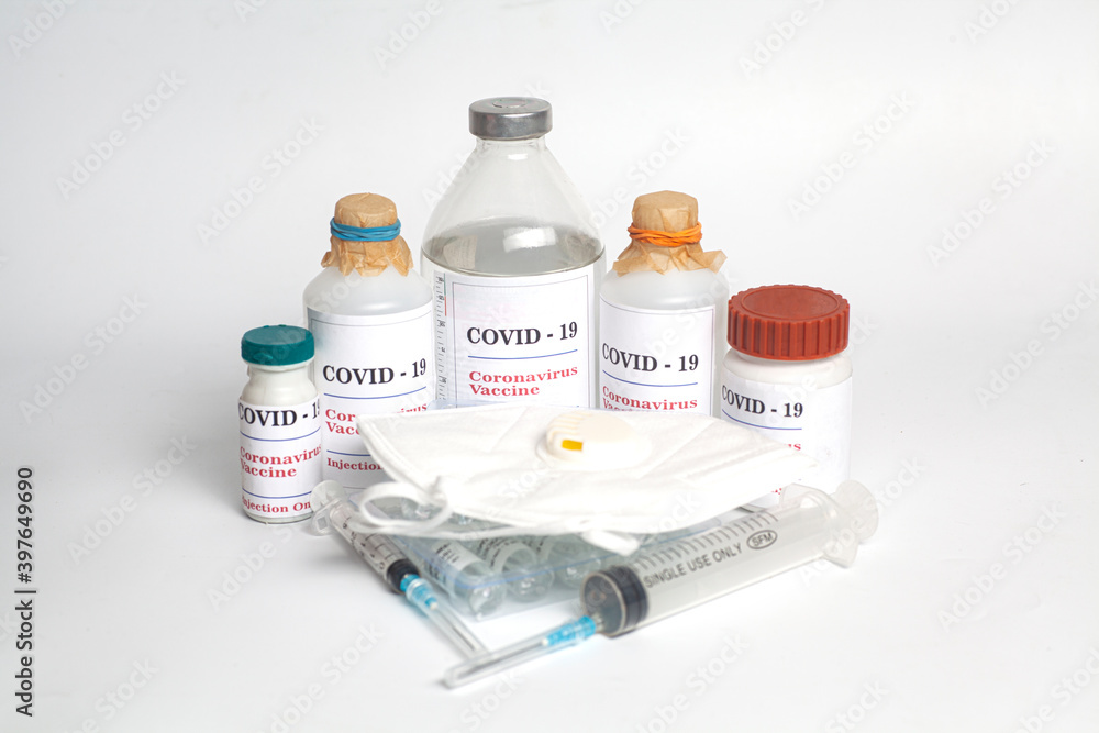 Coronavirus Vaccine injection vials medicine drug bottles Covid-19 with syringe and medical mask Coronavirus Vaccine injection vials medicine drug bottles Covid-19 with syringe and medical mask