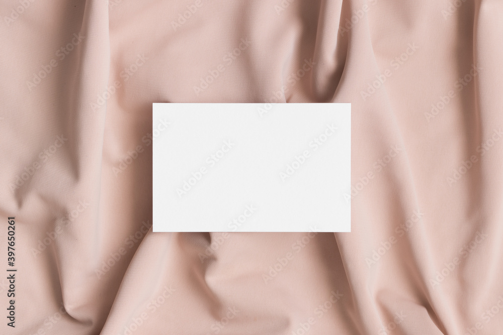 White business card mockup on a beige textile. 85x55mm White business card mockup on a beige textile. 85x55mm