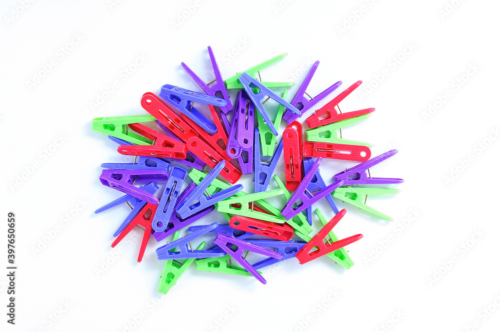 Multi-colored clothespins heap on white background. Multi-colored clothespins heap on white background.