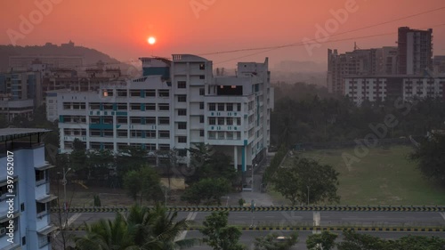 Navi Mumbai Seawood sunrise behind  tilak group of instituted  seawoods bridge traffic car passing orange sky photo