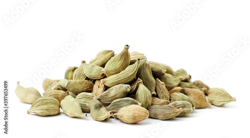 Heap of whole cardamom pods on a white background. Isolated