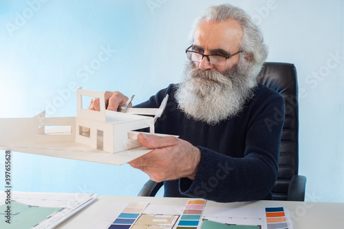 Senior architect at desk. E...