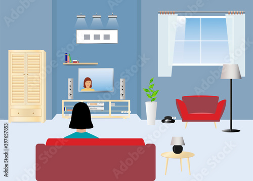 Woman is sitting on the couch in the living room and watching TV