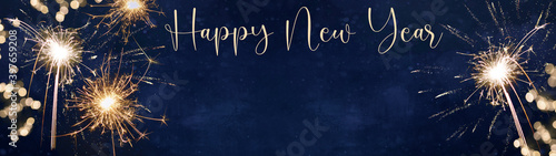 Happy New Year - Silvester background banner panorama long- sparklers and bokeh lights on dark blue night sky texture 