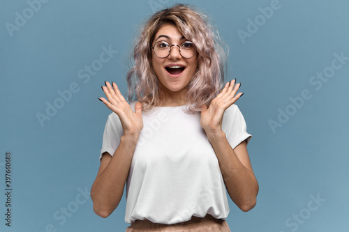 Quadro em tela Overjoyed cute young woman with nose ring gesturing excitedly, opening mouth widely, happy to get amazing unexpected present