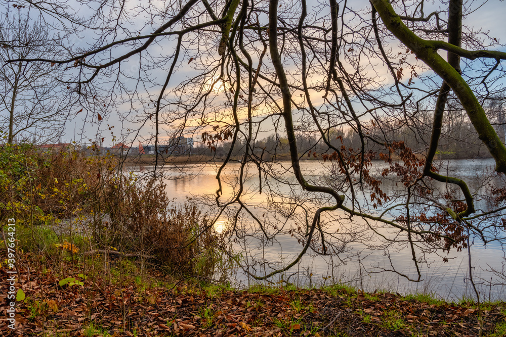 A beautiful sunset picture over a little lake. Photo from Lomma Beach, Scania county, Sweden A beautiful sunset picture over a little lake. Photo from Lomma Beach, Scania county, Sweden