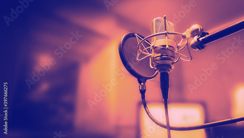 Studio microphone with shock mount and pop filter on tripod stand for sound engineer and singer or announcement on air studioroom. microphone and equipment concept.