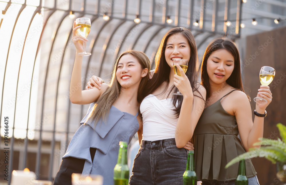 Happy Young Asian Women Gang Drinking Champagne While Enjoying Rooftop
