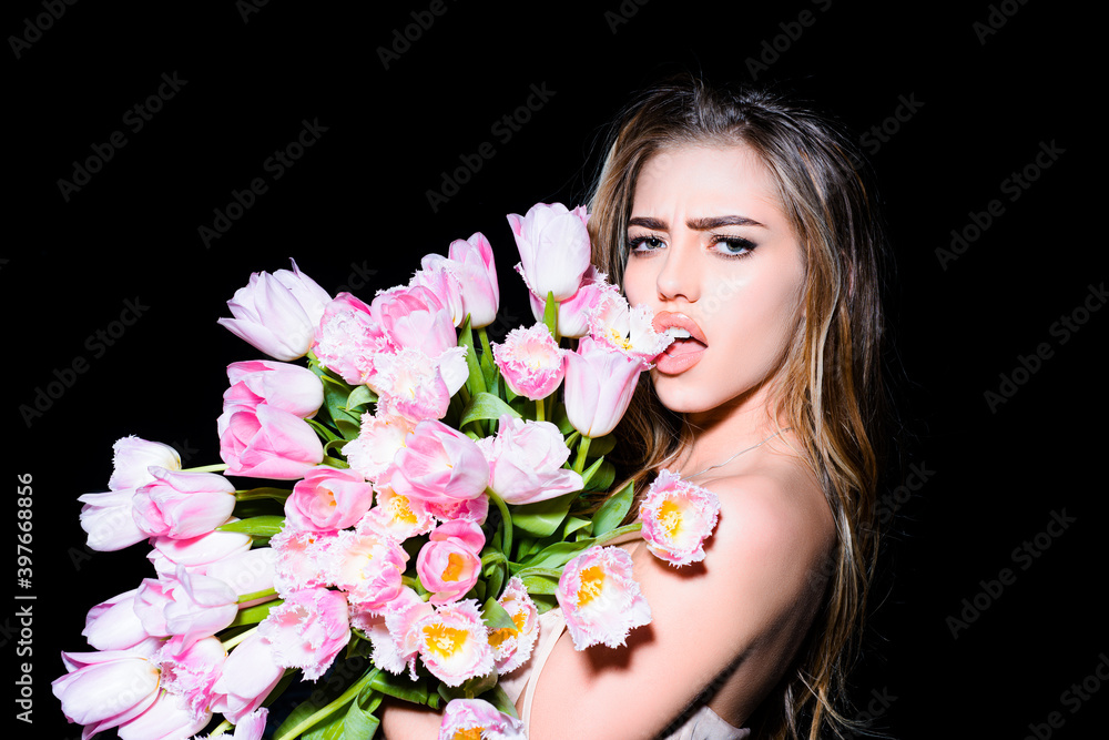 Sensual girl with tulips flowers bouquet isolated on black.