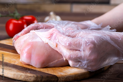 The chef removes the skin from the chicken breast to reduce the amount of fat in the food