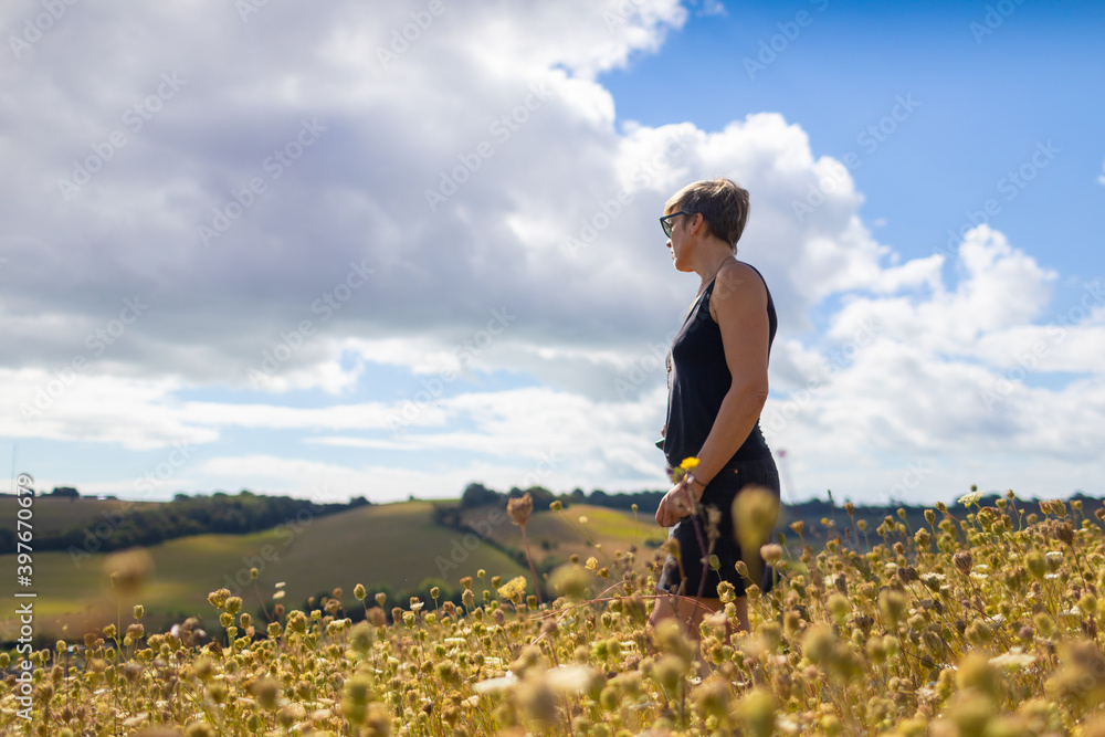 Fototapeta premium woman in field walking and relaxing