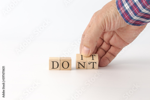 Male hand flipping wooden cubes for change wording from 