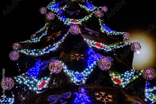 Christmas tree illuminated with the many colorful lights © ihorbondarenko