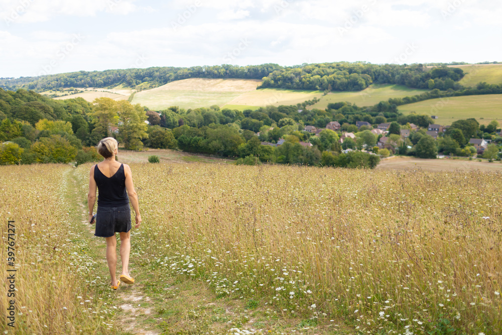 woman in field, walking and relaxing woman in field, walking and relaxing