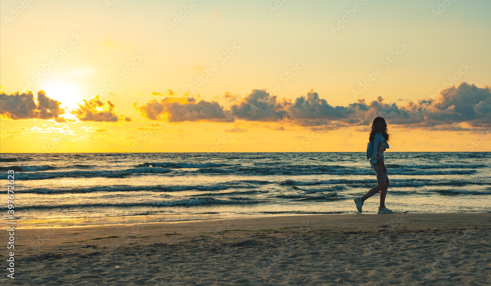 lone girl on sunset beach