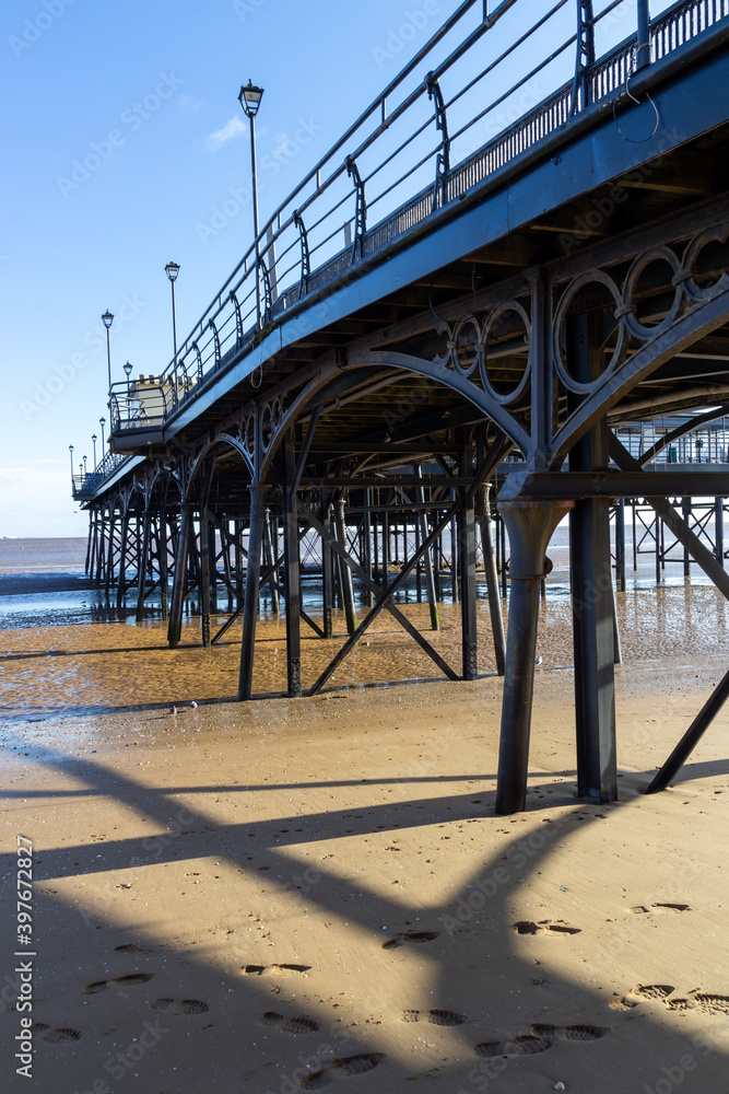 Underside view of a Pier with sand and water