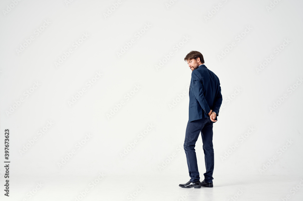 business man on a light background in a classic suit Copy Space back view