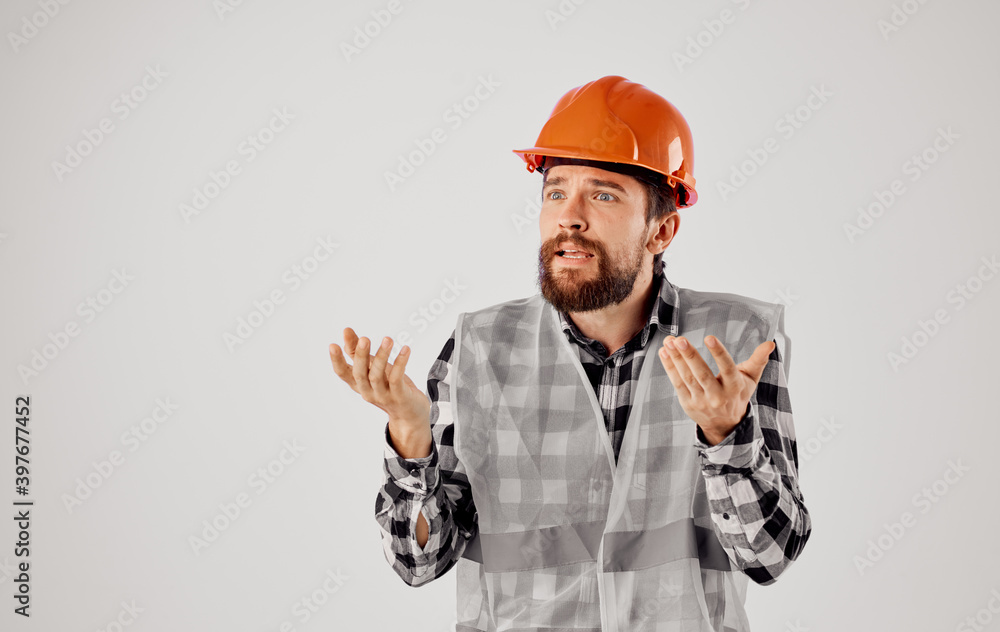 Construction worker in uniform orange helmet safety work