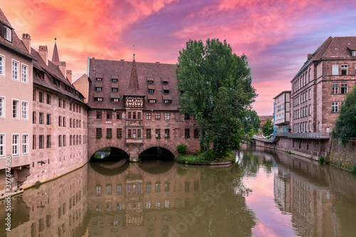 Nurnberg Hospital of the Holy Ghost building over Pegnitz river. View from the Bridge on the River Pegnitz. Nuremberg, Germany. photo