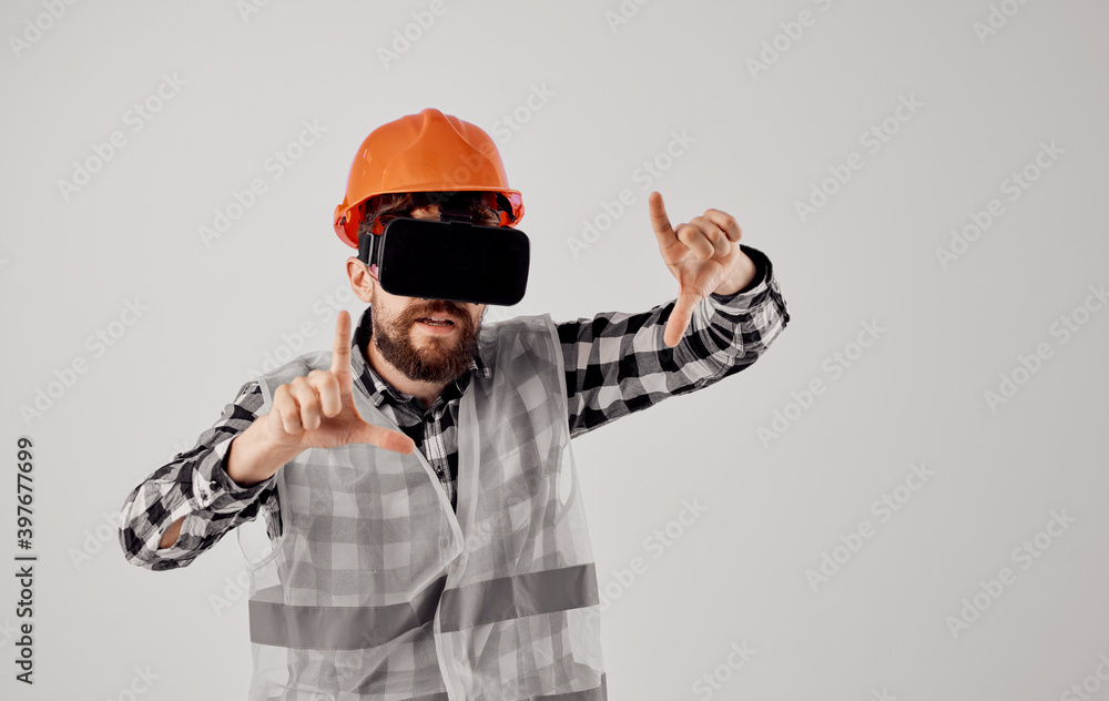 civil engineer in orange helmet checkered shirt 3d glasses gesturing with hands civil engineer in orange helmet checkered shirt 3d glasses gesturing with hands