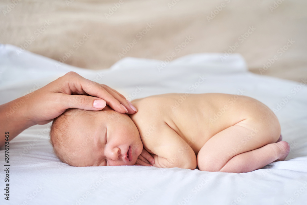Newborn tiny head. Mother touch little people. Healthcare concept. Modern parenthood. Comfort and safety sleep on bed. Human insurance. Family miracle. Closed eyes Newborn tiny head. Mother touch little people. Healthcare concept. Modern parenthood. Comfort and safety sleep on bed. Human insurance. Family miracle. Closed eyes