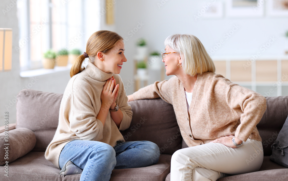 Happy women chatting on sofa at home. Happy women chatting on sofa at home.