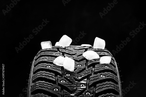 winter studded tyre decorated ice bricks. studio shot. tyres industry concept. copy space