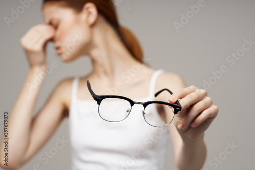 woman in white t-shirt glasses vision problems myopia