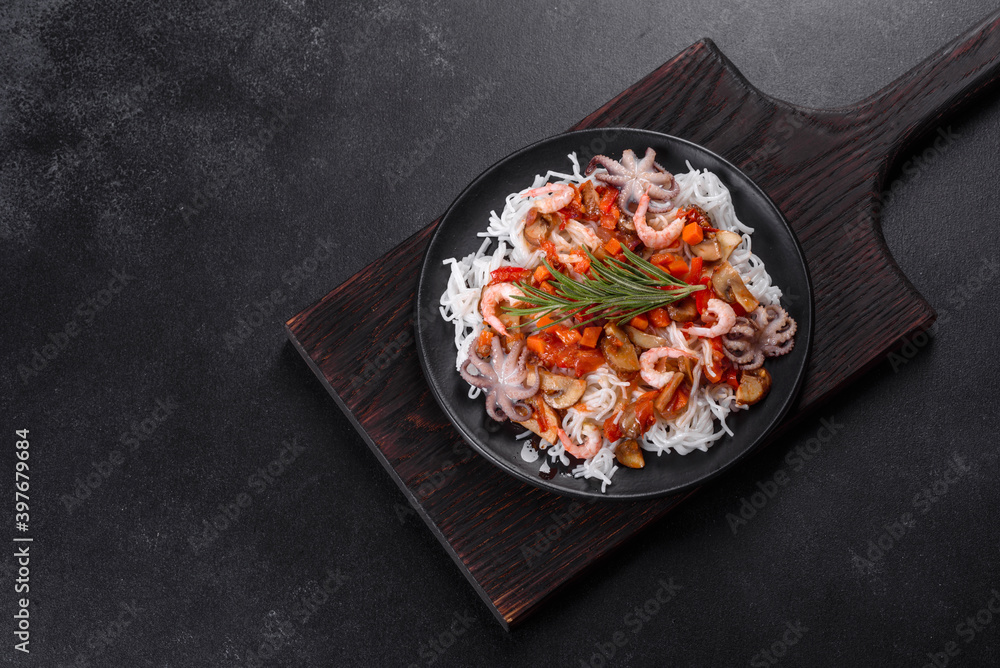 Tasty rice noodles with tomato, red pepper, mushrooms and seafood Tasty rice noodles with tomato, red pepper, mushrooms and seafood