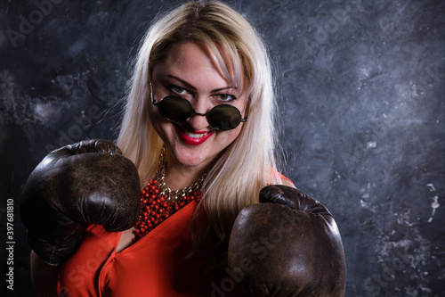 Attractive plump woman with boxing gloves studio portrait. photo