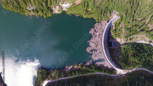 фотографія Top aerial drone view of Galbenu Lake full of tree trunks from the deforestation happening along it