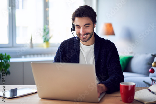 Man doing tele work from home during Christmas