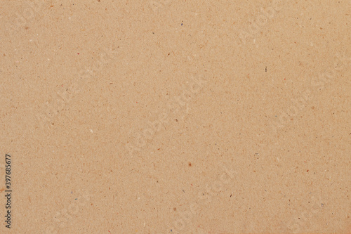 Cardboard, brown paper texture background close-up, surface with inclusions of cellulose