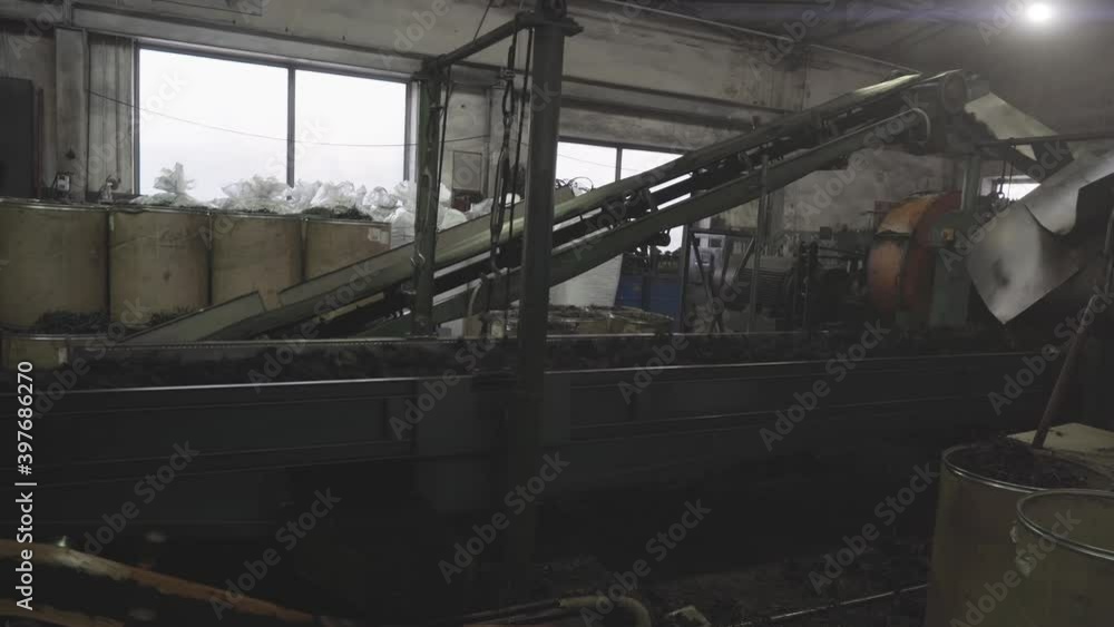 Rubber recycling processing factory on special industrial equipment and conveyor line with cut used car tires. Recycling waste, saving environment from pollution. Rubber recycling processing factory on special industrial equipment and conveyor line with cut used car tires. Recycling waste, saving environment from pollution.