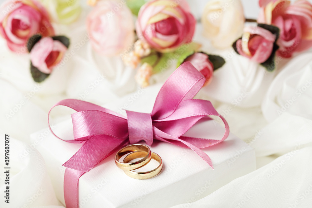wedding rings and gift box and pink flowers. love symbol wedding rings and gift box and pink flowers. love symbol