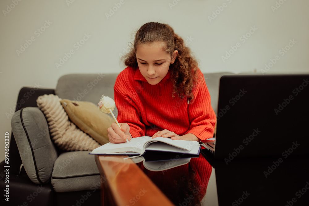 Girl attending online classes from home.Girl using laptop for connecting with teacher and schoolmates. School education and social distance during quarantine Girl attending online classes from home.Girl using laptop for connecting with teacher and schoolmates. School education and social distance during quarantine