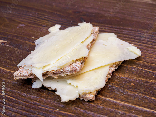 Top view of crispbread with cheese on a wooden table