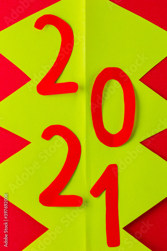 Green New Year tree made of paper. Christmas tree on a red background. New Year's concept 2021. Top view