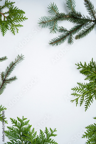 Christmas frame with new year tree branches. Christmas wallpaper. Flat lay  top view with empty space in center for text with greetings.