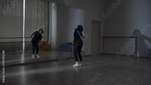 Wallpaper Mural A wide shot of a dance studio where a young girl dances in front of a mirror in various directions of modern dance. Torontodigital.ca