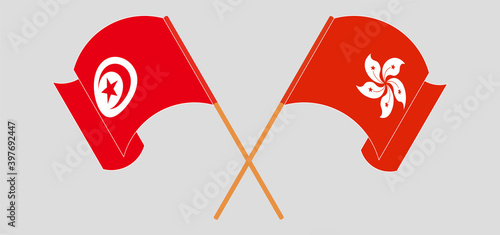 Crossed and waving flags of Tunisia and Hong Kong