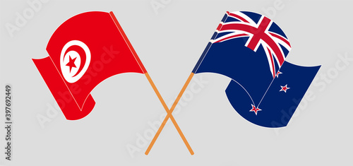 Crossed and waving flags of Tunisia and New Zealand